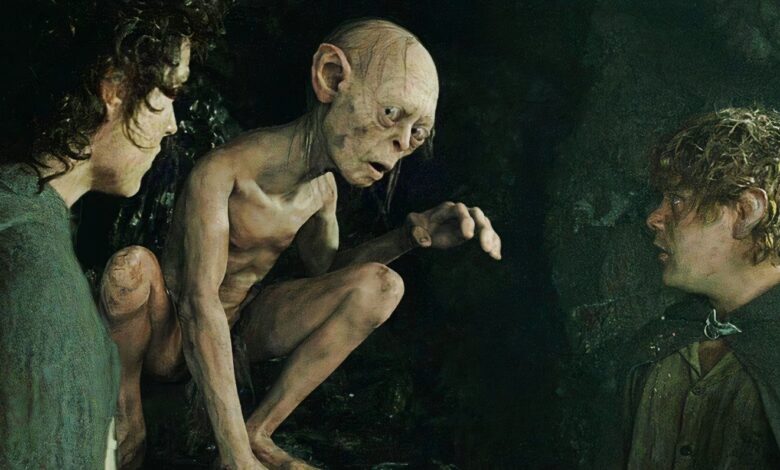 gollum crouching between frodo and sam in a cave in the lord of the rings return of the king