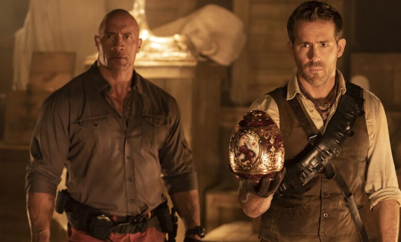 Dwayne The Rock Johnson as John Hartley and Ryan Reynolds as Nolan Booth Holding the Cleopatra Egg in Red Notice